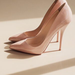 A pair of pink high heels sitting on top of a table.