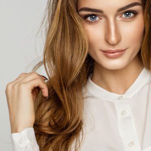 A woman with long hair is posing for the camera.