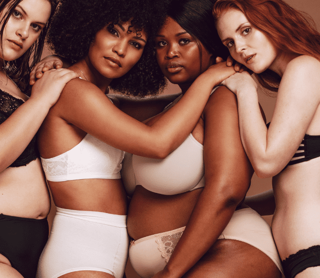 A group of women in white underwear posing for the camera.