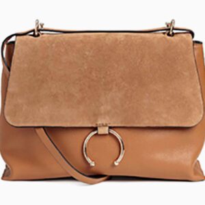 A brown bag with a metal ring on the front.