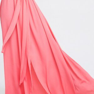 A pink dress is draped over the side of her body.