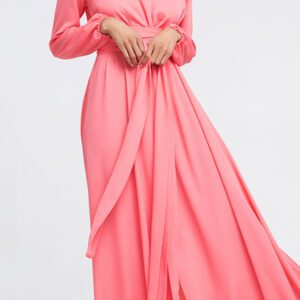 A woman in pink dress standing on top of a white floor.