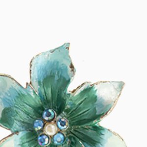 A close up of the flower with blue and green leaves
