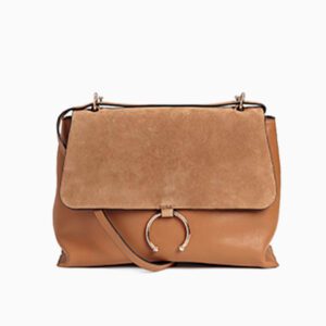 A brown bag with a metal ring on the front.
