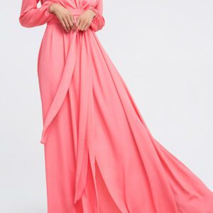 A woman in a pink dress standing on the ground