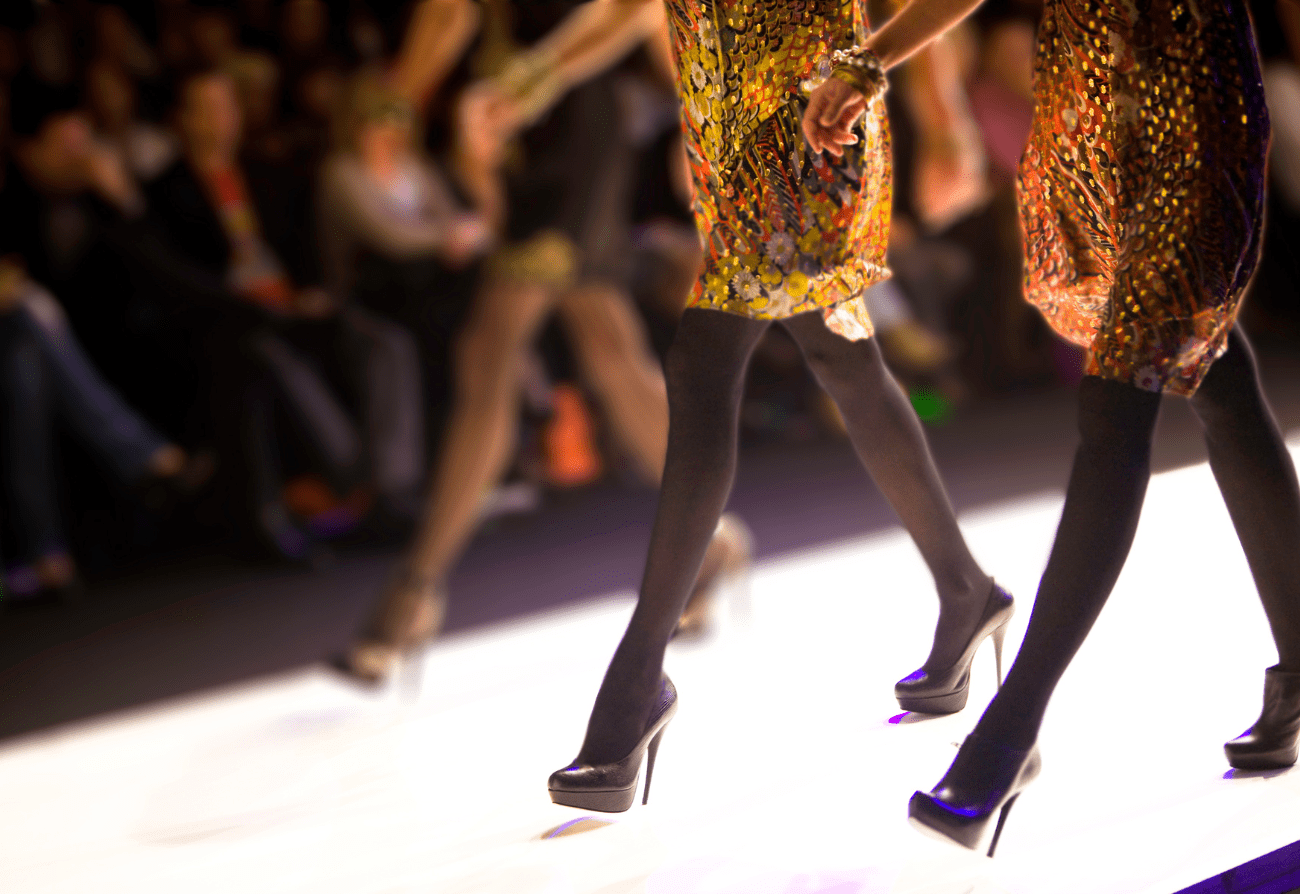 A close up of some people walking on the runway