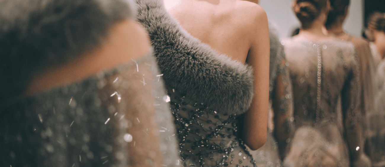 A woman in a dress with fur on it.