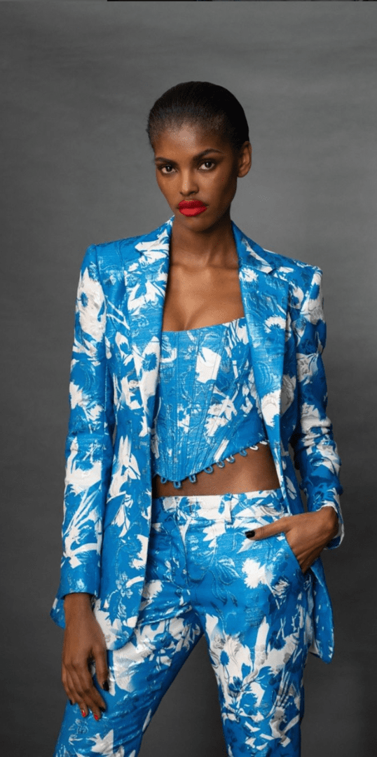 A woman in blue and white outfit with red lips.
