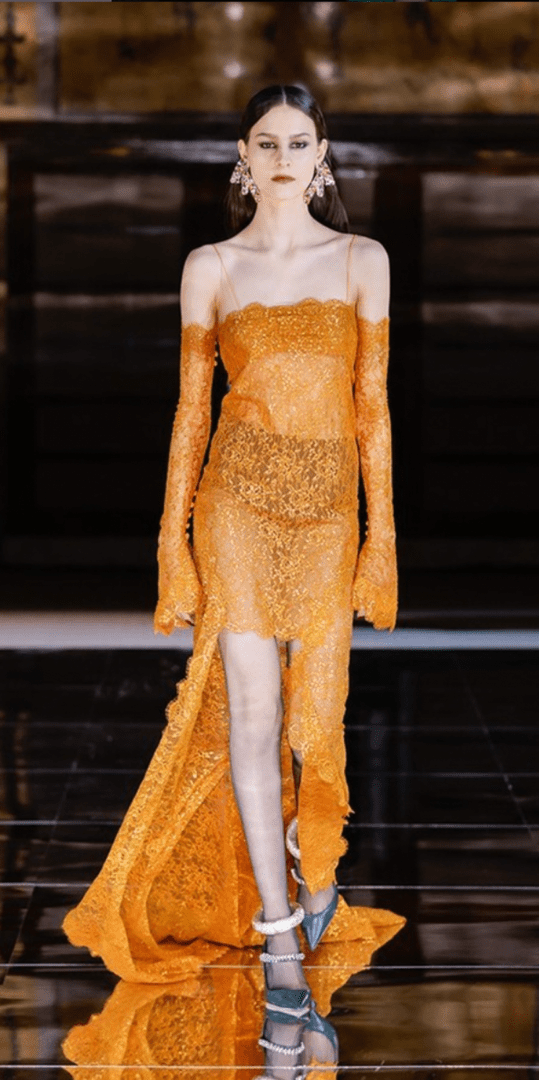 A woman in an orange dress made of bread.
