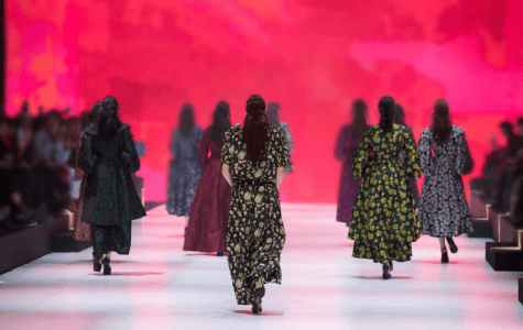 A group of women walking on the runway.