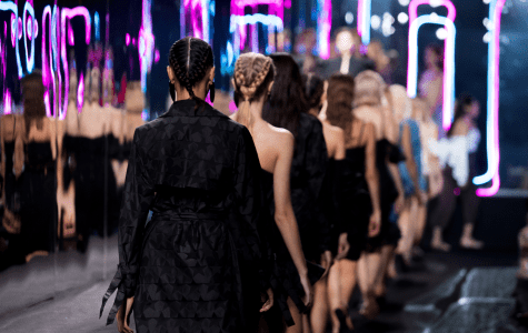 A group of women in black dresses are walking down the street.